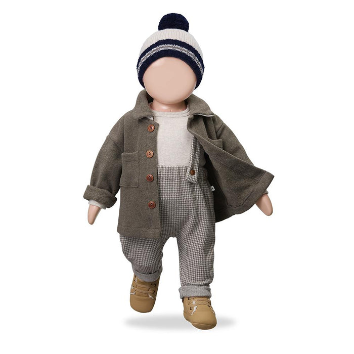 A baby boy's winter outfit displayed on a mannequin doll, featuring a brown corduroy jacket, a grey and white gingham overalls set, a light grey knit top, tan boots, and a navy and white striped beanie with a pom-pom.