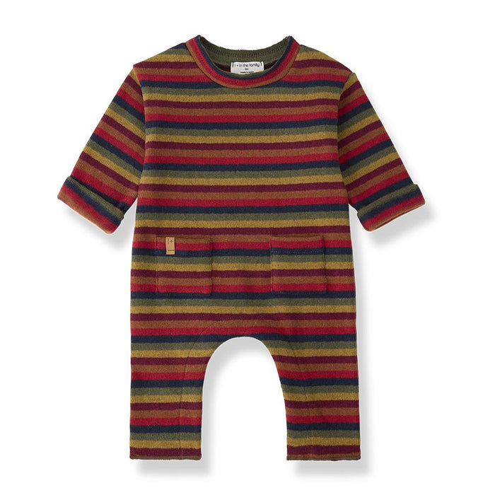 A baby long-sleeve romper with horizontal stripes in red, mustard yellow, navy blue, and olive green, featuring an open crotch and a small fabric brand tag on the left chest.