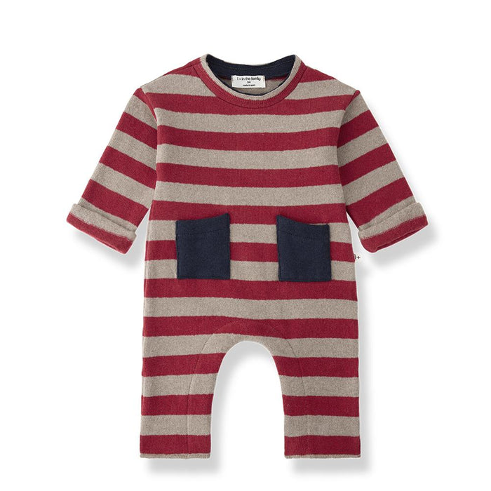 A baby long-sleeve romper with horizontal red and beige stripes, featuring two dark navy blue front pockets and an open crotch design, shown on a white background.
