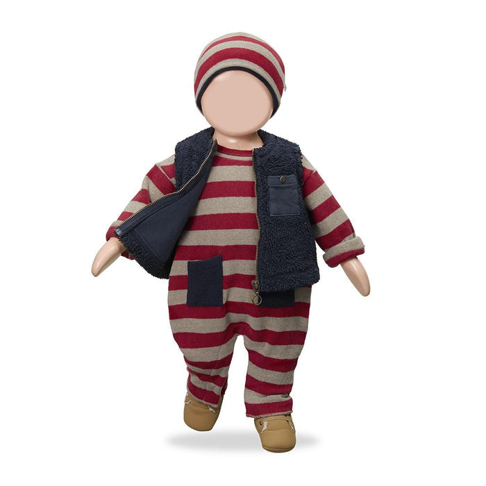 A doll or mannequin dressed in a red and beige striped one-piece outfit with a navy fleece vest, matching striped beanie, and tan shoes, shown against a plain white background.