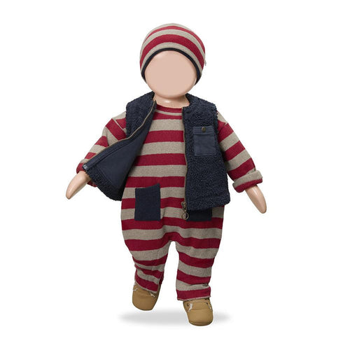 A doll or mannequin dressed in a red and beige striped one-piece outfit with a navy fleece vest, matching striped beanie, and tan shoes, shown against a plain white background.