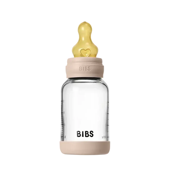 Clear baby bottle with beige cap and neck, featuring the 'BIBS' brand on a white background.