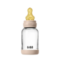 Clear baby bottle with beige cap and neck, featuring the 'BIBS' brand on a white background.