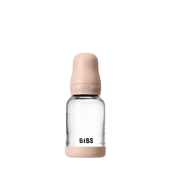 Clear baby bottle with pink cap and 'BIBS' branding on a white background
