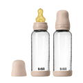 Two clear baby bottles with pink caps and nipples on a white background, branded 'Bibs'.