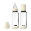 Two clear baby bottles with beige caps and 'Bibs' branding on a white background