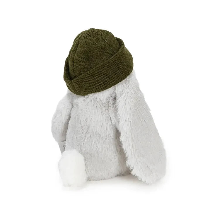 A plush bunny toy shown from the back, wearing an olive green knit beanie and a white fluffy body with long ears and a white tail, on a plain white background.