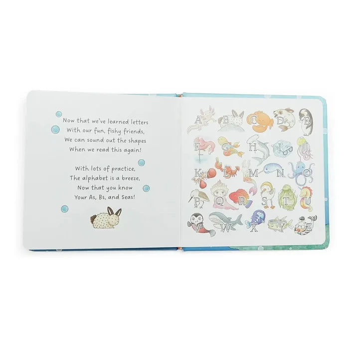 Open book with alphabet illustrations and text on a white background