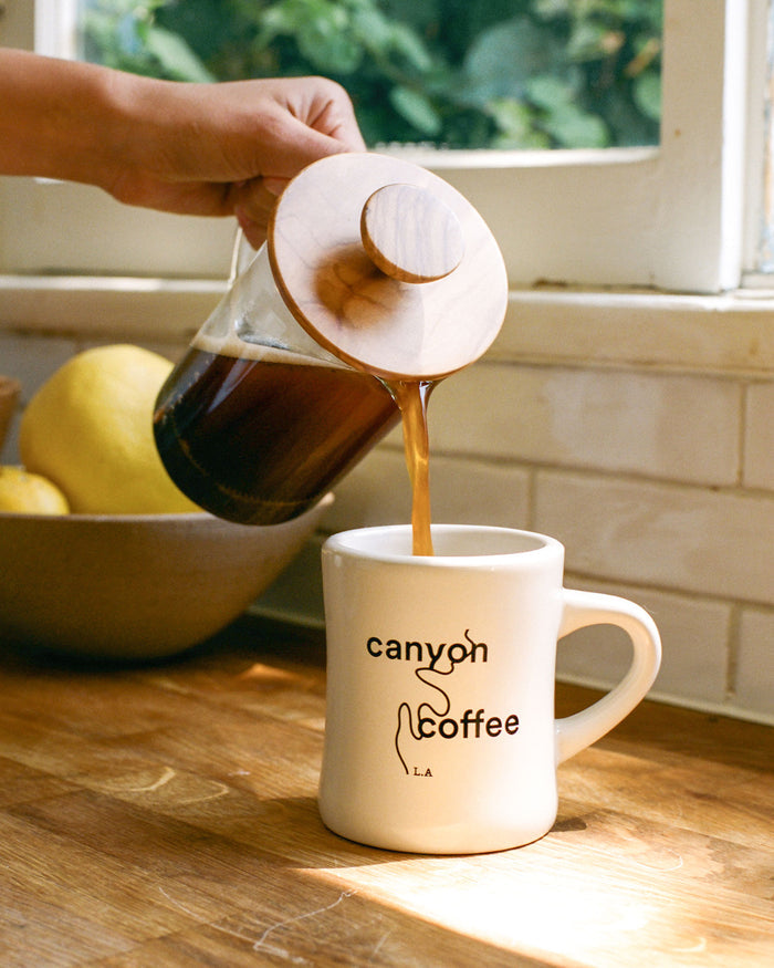 A cream classic diner mug with Canyon Coffee logo
