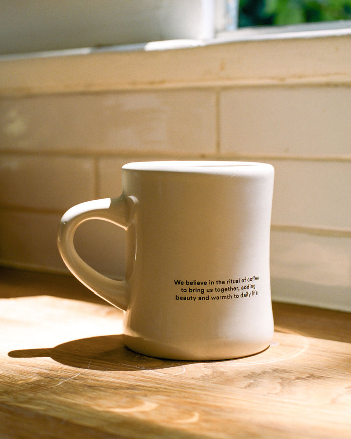 A cream classic diner mug with Canyon Coffee logo