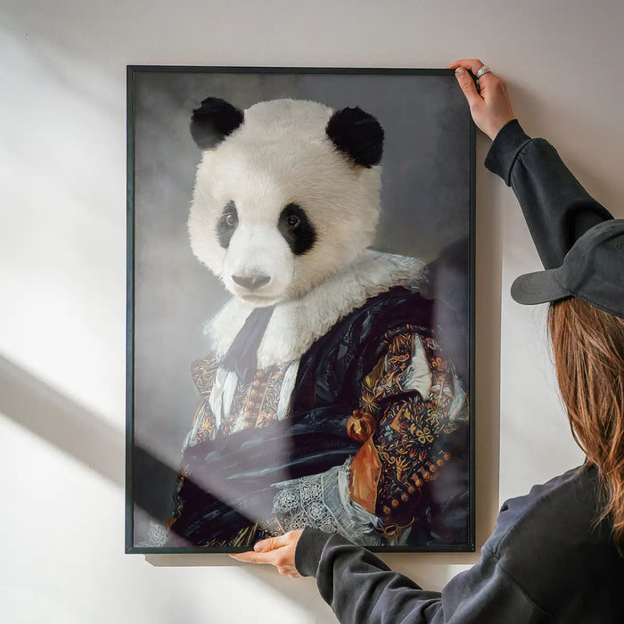 Cavalier Panda Portrait Print being hung on a wall in a black frame