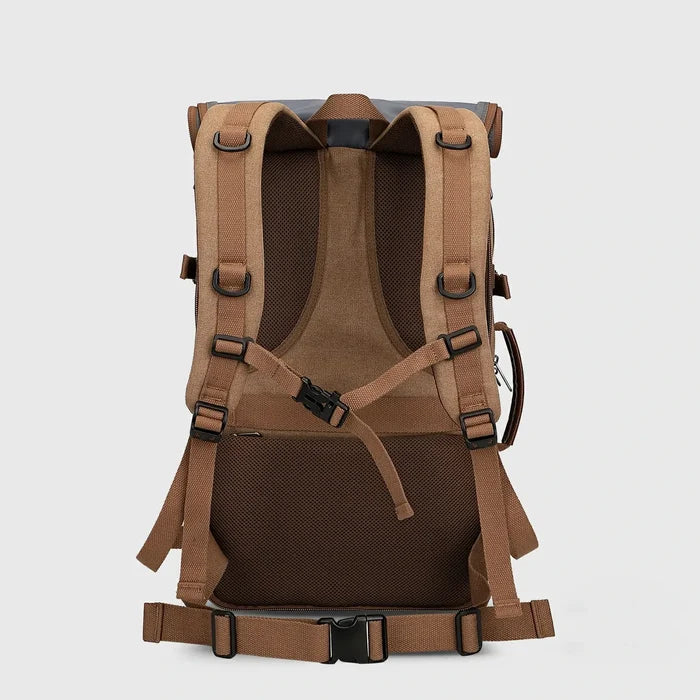 Back view of brown canvas travel backpack with breathable padding, chest strap and waist belt
