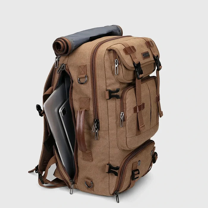 Close-up of ventilated shoe compartment inside brown canvas travel backpack for men