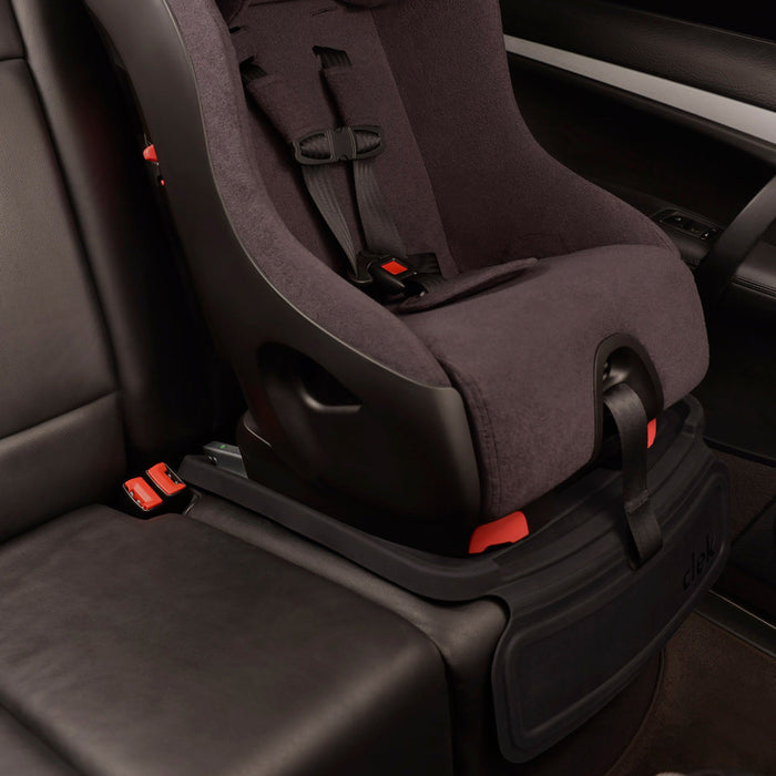 Child car seat installed in a vehicle with mat protector