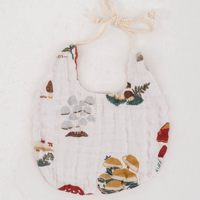 Baby bib with nature-themed print on a white background