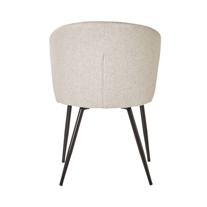 The Cole Dining Chair Clay features clay-colored upholstery, a rounded backrest, and four black metal legs, adding contemporary elegance and modern style to any space.