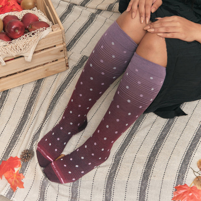 Woman wearing knee high compression socks dots on ombre for daily comfort and circulation