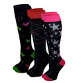 Three pairs of knee-high socks displayed together on a white background. The front pair is black with silver and pink stars, bright pink cuffs, and pink toes.