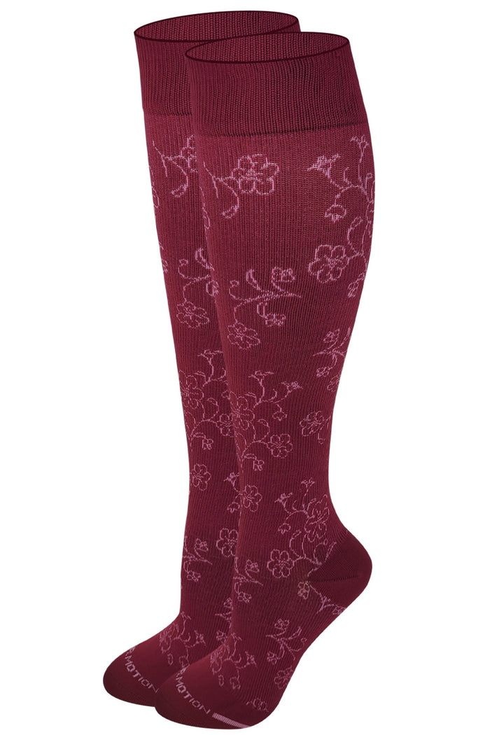 Pair of maroon knee-high socks with floral pattern on a white background