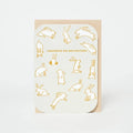 Greeting card with gold rabbit illustrations and text on a white background