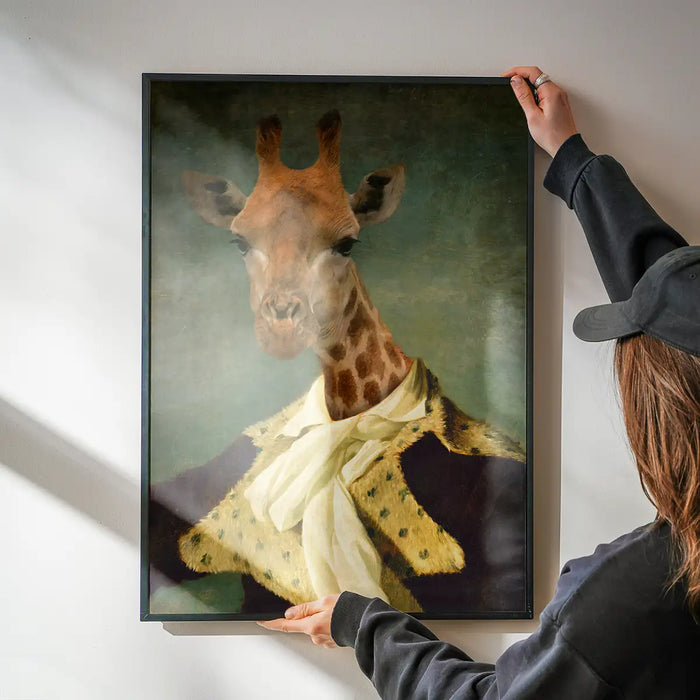 Giraffe Portrait Print being hung on a wall in a black frame