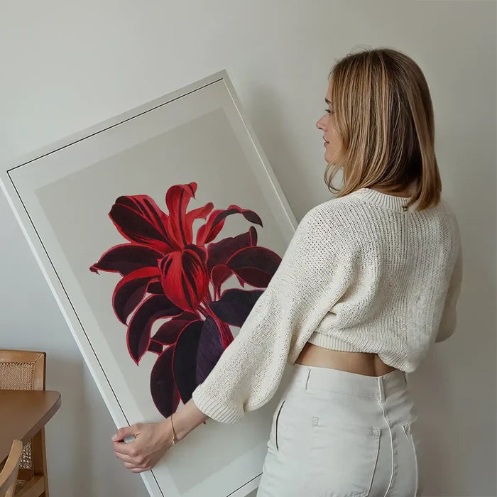 Hand drawn Hawaiian Ti plant print held up against a living room wall