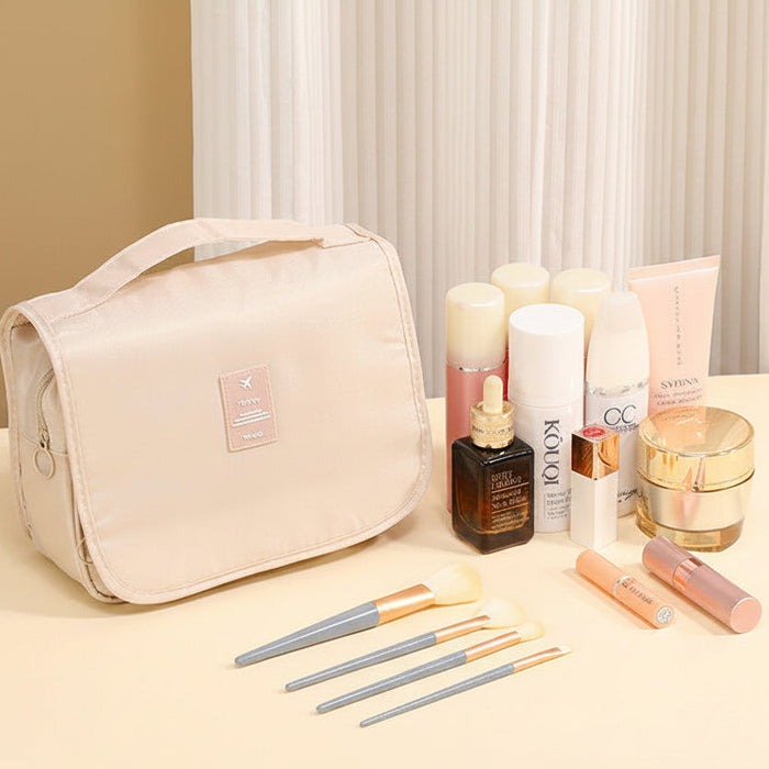 Hanging toiletry organizer displayed with skincare and makeup essentials on a vanity