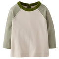 A long-sleeve raglan-style top for a baby or toddler, featuring an off-white body and muted sage green sleeves with a darker olive green crew neck collar.