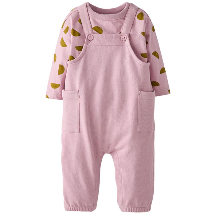 A baby's long-sleeve romper in light pink corduroy-style fabric, featuring a matching pink long-sleeve shirt underneath with olive green semicircle patterns on the sleeves. The romper has adjustable shoulder straps with two buttons, front patch pockets, and elastic cuffed ankles.