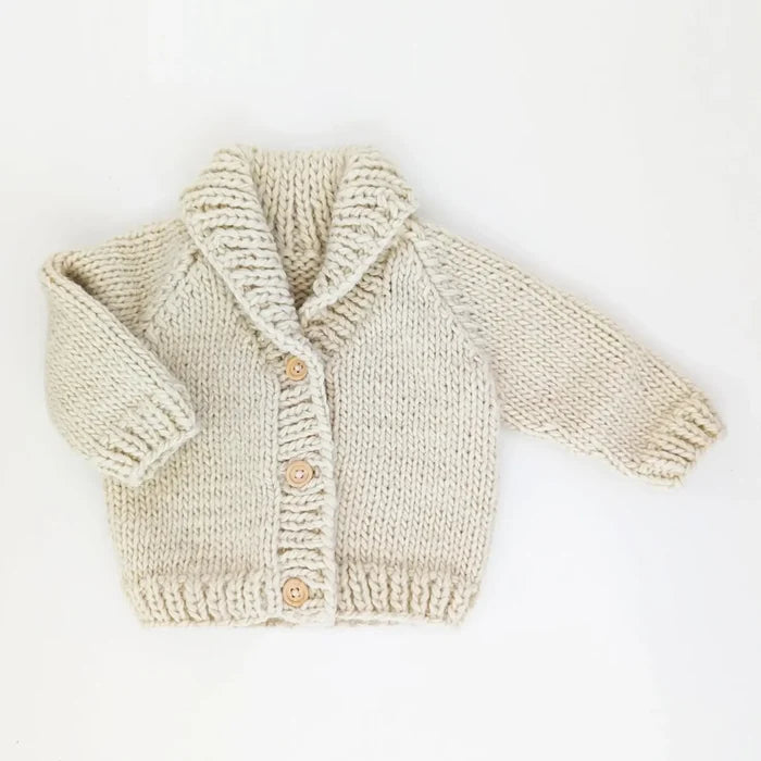 Knitted baby cardigan on a white background