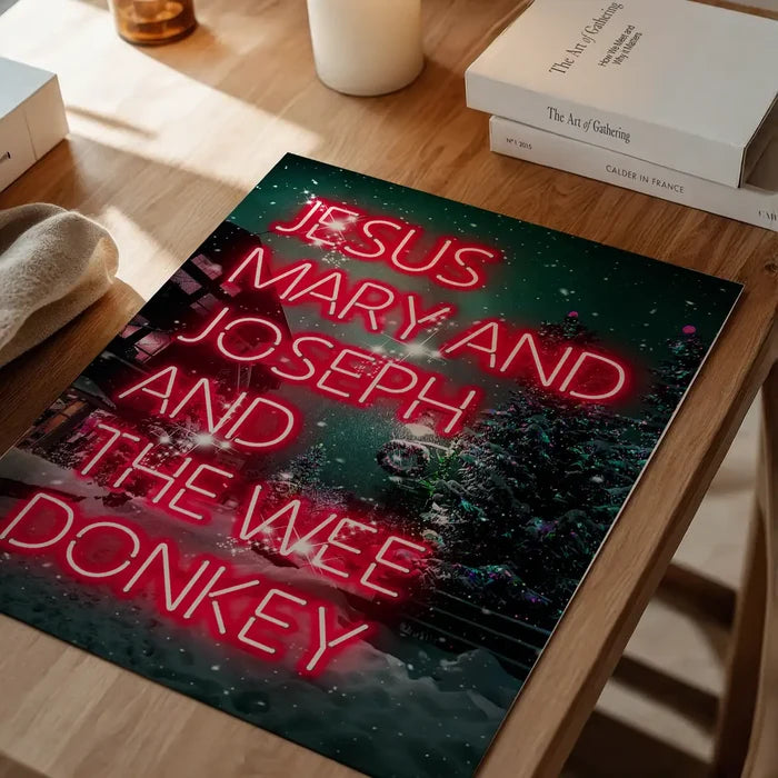 Jesus, Mary, Joseph & The Wee Donkey Christmas Print unframed on a home office desk