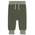 A pair of knit baby pants in olive green with a contrasting sage green waistband and drawstring, set against a plain white background.