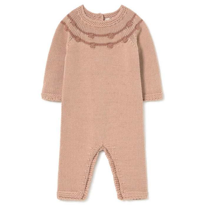 A dusty pink hand-knit baby jumpsuit with a decorative patterned yoke, shown flat on a white background.