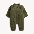 An olive green corduroy baby jumpsuit with short sleeves, a button-up front, two chest pockets, and elastic cuffs, shown on a light gray background.