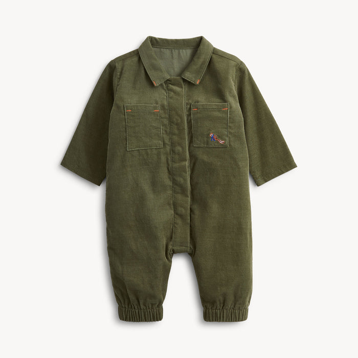 An olive green corduroy baby jumpsuit with short sleeves, a button-up front, two chest pockets, and elastic cuffs, shown on a light gray background.