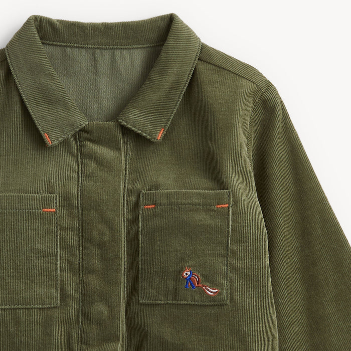 Close-up of an olive green corduroy jacket with a pointed collar, two front chest pockets, orange contrast stitching, and a small embroidered squirrel motif on the left chest pocket.