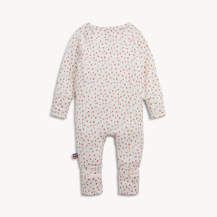 Back view of a baby long-sleeve romper with a white base, covered in a small pink apple pattern