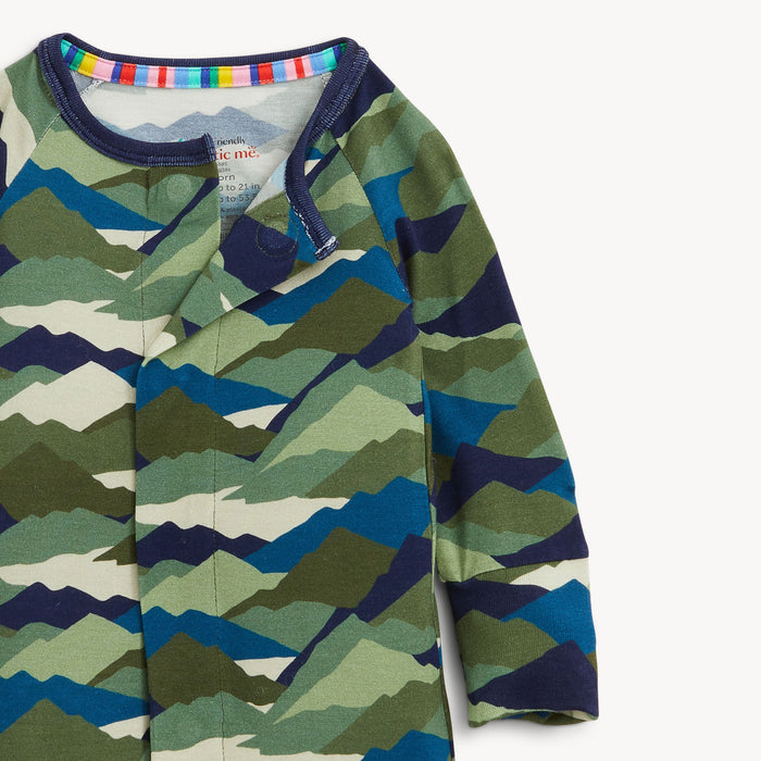 Up close shot of a camouflage-patterned romper depicting magnetic closure