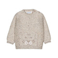 A beige knit sweater for toddlers, featuring a speckled texture with tiny multicolor flecks and a knitted tiger face motif on the front.