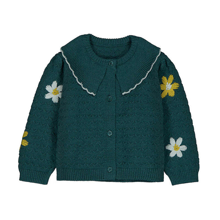 Teal knitted cardigan with floral designs on a white background