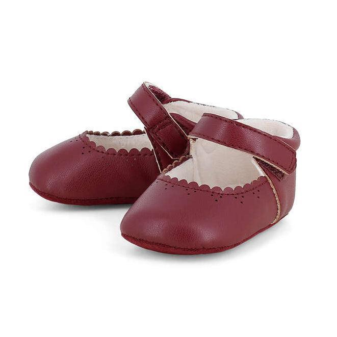 A pair of burgundy baby ballet flats with scalloped edges and adjustable straps, shown on a clean white background.