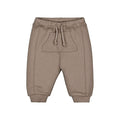 A pair of children's jogger sweatpants in a taupe-brown color, featuring an elastic waistband with a matching drawstring, side pockets, and ribbed ankle cuffs, shown against a plain white background.