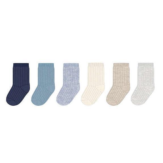 Six ribbed knit socks in different colors arranged in a row on a plain white background: navy, light blue, pale blue, cream, beige, and off-white.