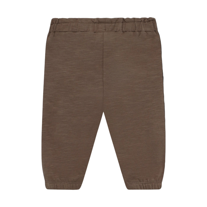 A pair of brown knit pants with an elastic waistband and elastic cuffs, shown flat against a solid black background.