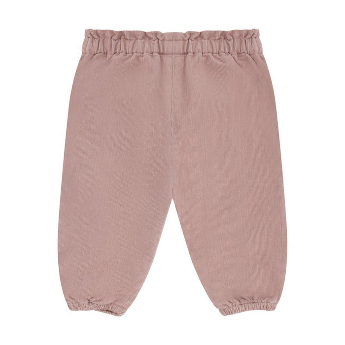 A pair of dusty rose pink corduroy pants with an elastic waistband and elasticized ankle cuffs, shown flat on a white background.