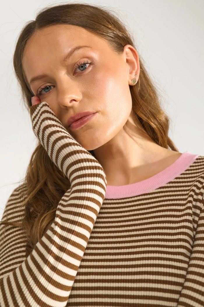 Close-up of a model wearing Numph 706923 NUFILINA Pullover – Dachshund with brown and cream stripes and a soft pink neckline by Numph. Shop Numph at Dotique.