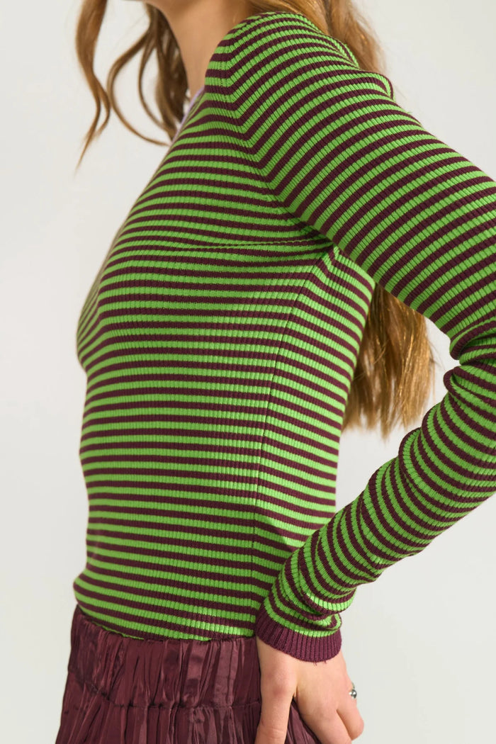 Side view of a model wearing Numph 706923 NUFILINA Pullover – Fig with green and dark purple stripes by Numph. Shop Numph at Dotique.