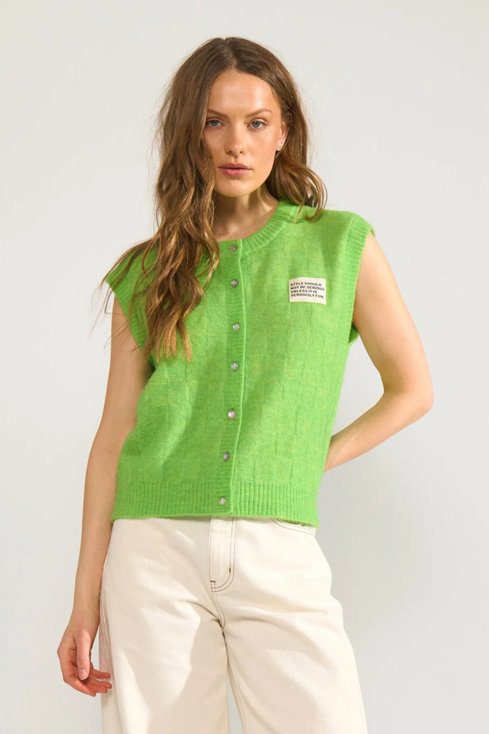 Model wearing Numph 706928 NURIETTE CHECK VEST – Jasmine Green with a sleeveless design and button front by Numph. Shop Numph at Dotique.