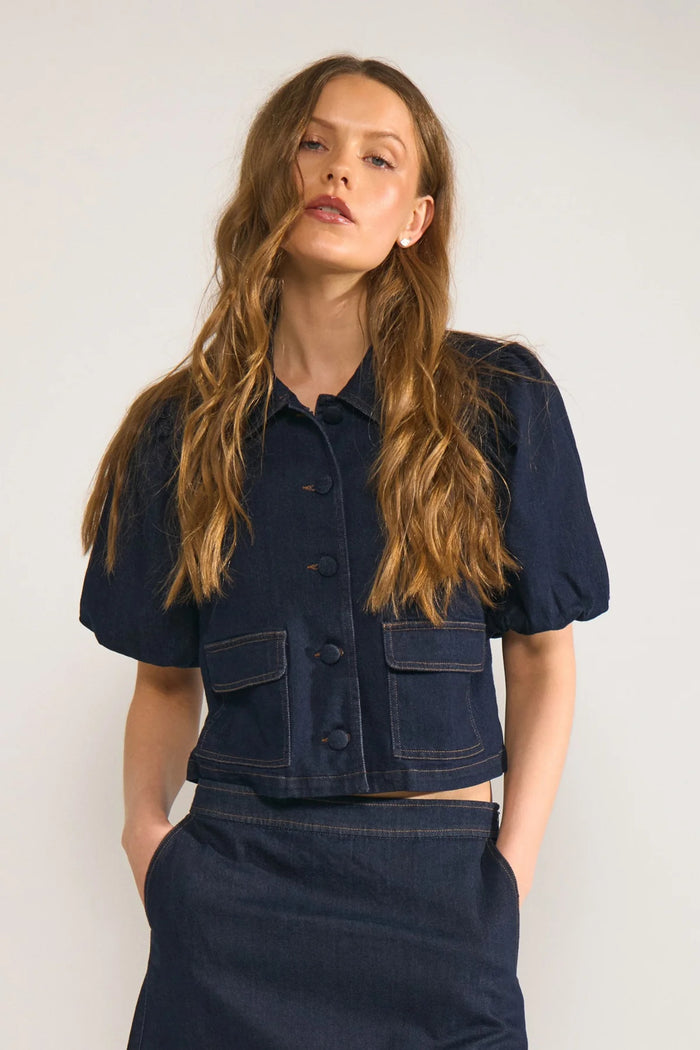 Model wearing Numph 707020 NUALETTA SS Shirt – Dark Blue Denim with puff sleeves and front pockets by Numph. Shop Numph at Dotique.