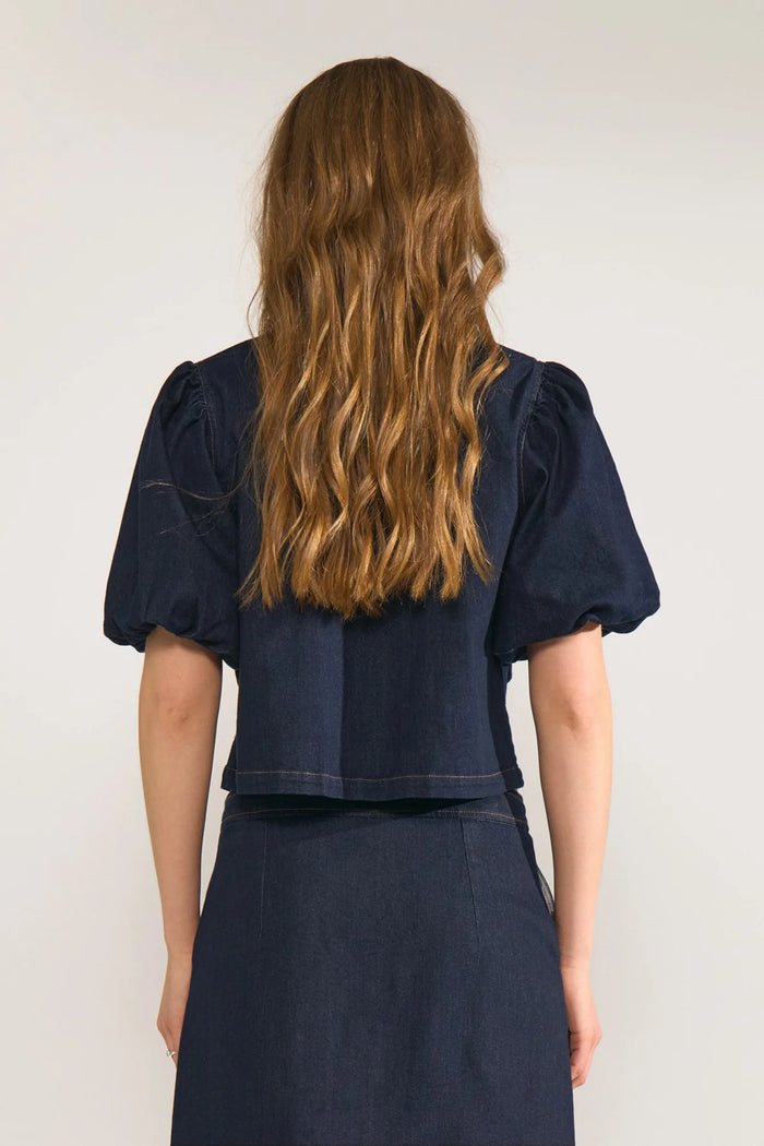 Back view of a model wearing Numph 707020 NUALETTA SS Shirt – Dark Blue Denim with puffed sleeves by Numph. Shop Numph at Dotique.